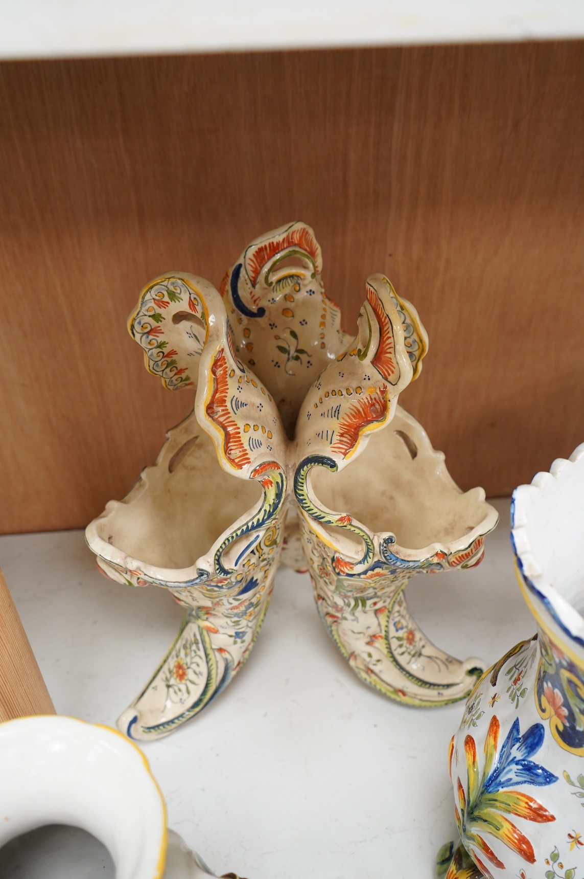 Two late 19th / early 29th century French faience vases and two similar centrepieces, largest 35cm high